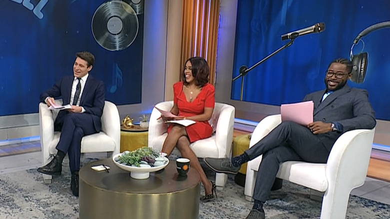 Gayle King sitting and talking with Tony Dokoupil and Nate Burleson on either side