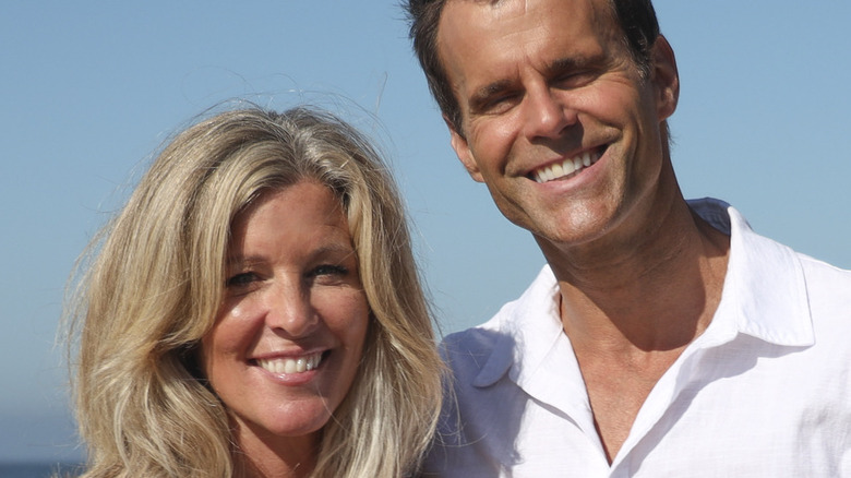 Laura Wright and Cameron Mathison smiling on the beach