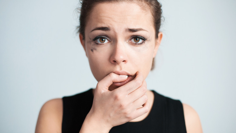 woman with smudged eye makeup 