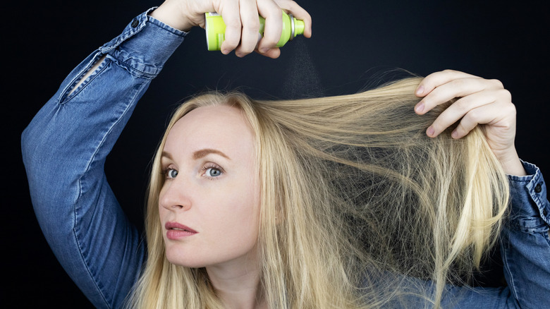 Woman with long hair using dry shampoo