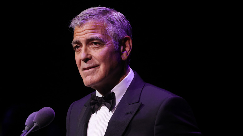 George Clooney speaking at microphone