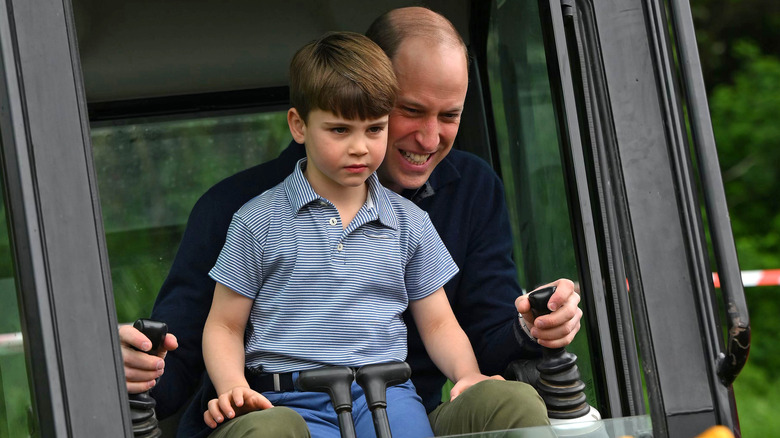 Prince William and Prince Louis operating a digger