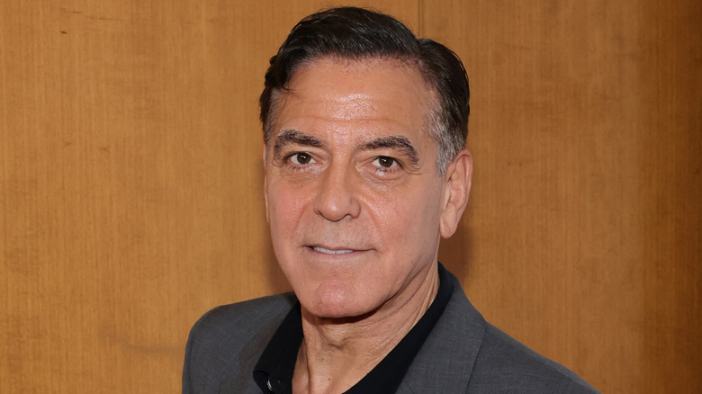 George Clooney poses with dyed black hair