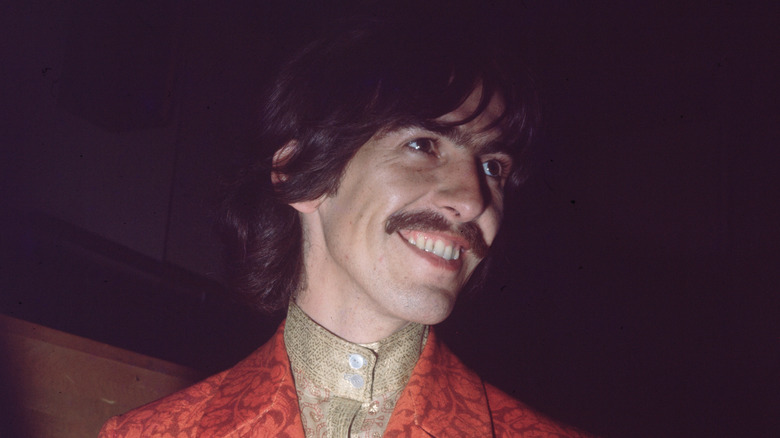 George Harrison smiling with a huge grin