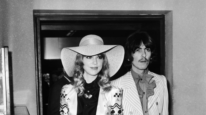Pattie Boyd and George Harrison smiling and posing.