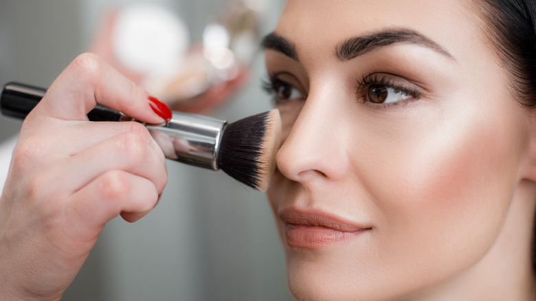Woman applying makeup