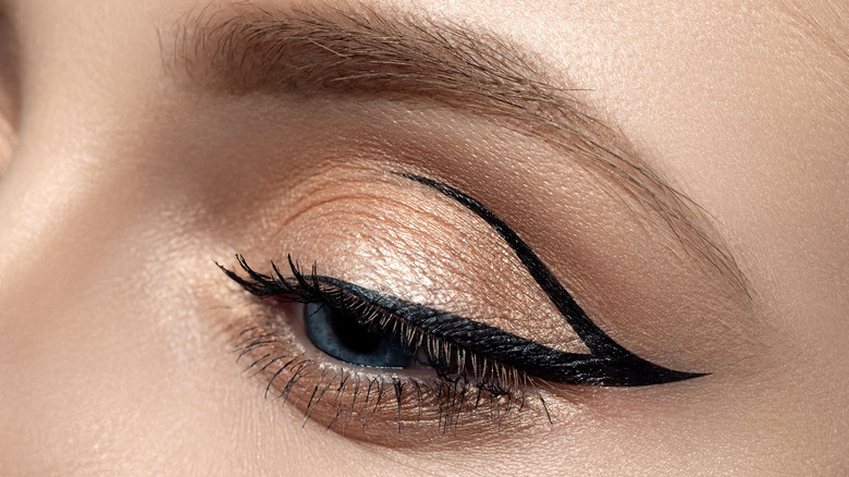 Close up of woman's eye with graphic winged eyeliner