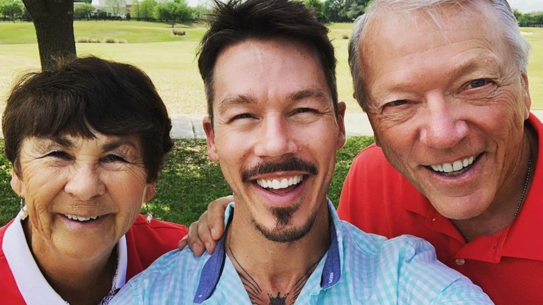 David Bromstad posing between his mom and dad