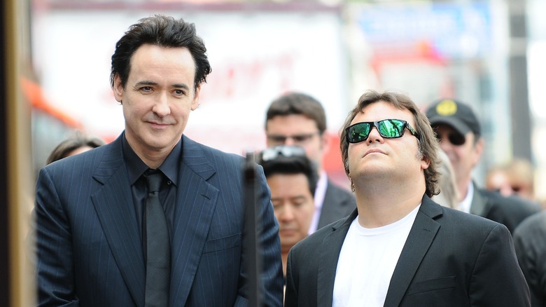 John Cusack and Jack Black attending an outdoor event.