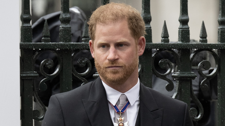 Prince Harry looking serious coronation