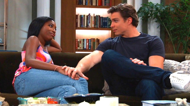 Trina and Spencer talking on a couch
