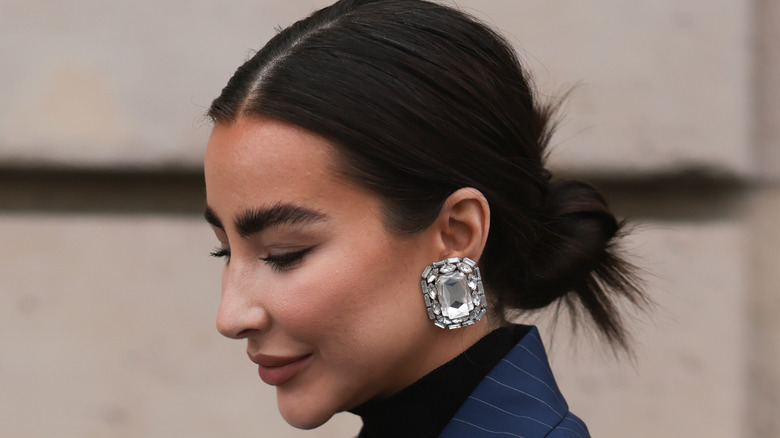 woman big gemstone silver earrings