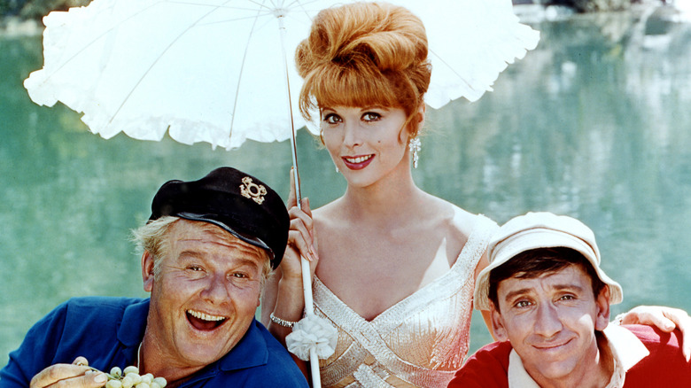 Alan Hale Jr. (1921 - 1990) as The Skipper, Tina Louise as Ginger Grant and Bob Denver (1935 - 2005) as Gilligan in the television series 'Gilligan's Island', circa 1964.