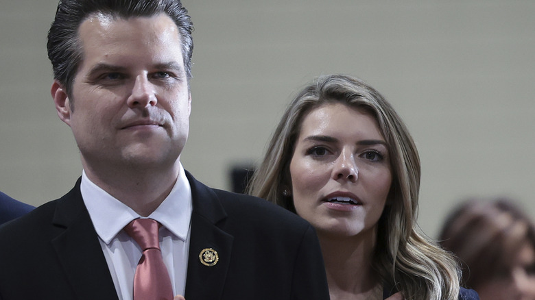 Ginger Luckey Gaetz standng behind Matt Gaetz at an event