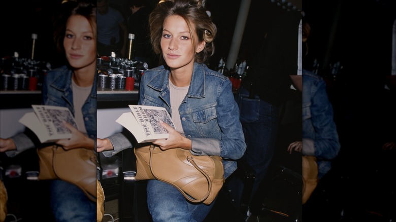 A young Gisele Bündchen backstage at a fashion show in 2000