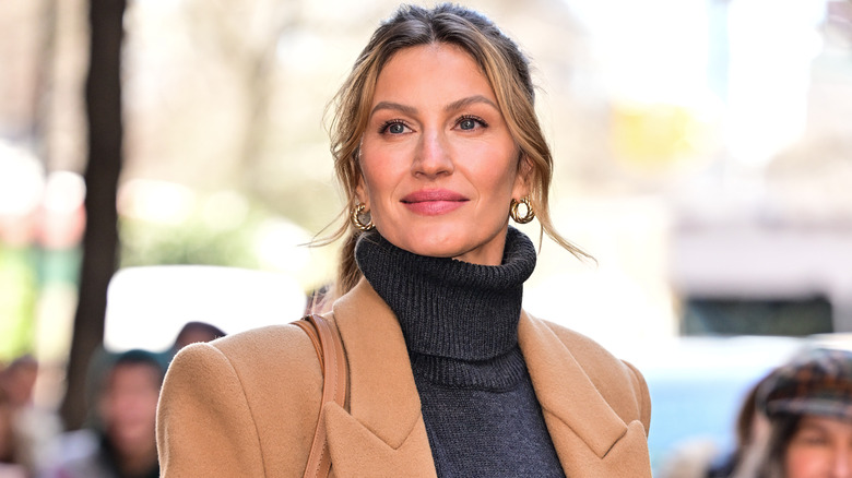 Gisele Bündchen in a gray turtleneck and tan coat