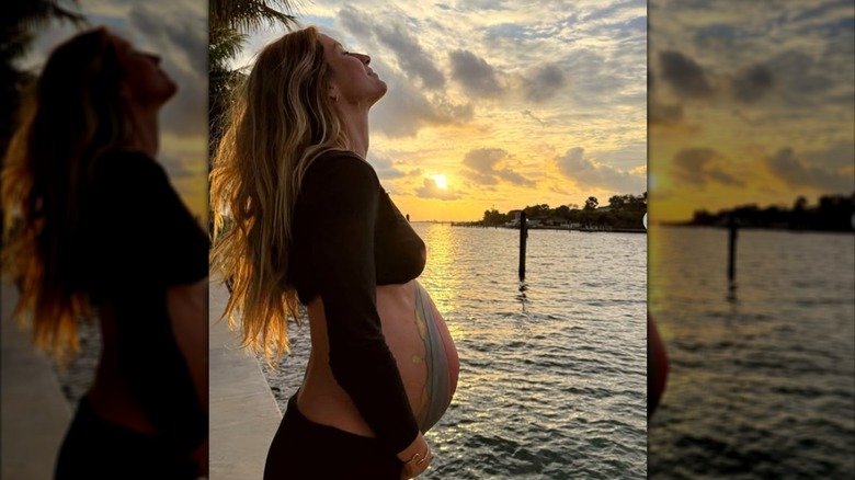 A pregnant Gisele Bündchen smiles for a photo in 2025