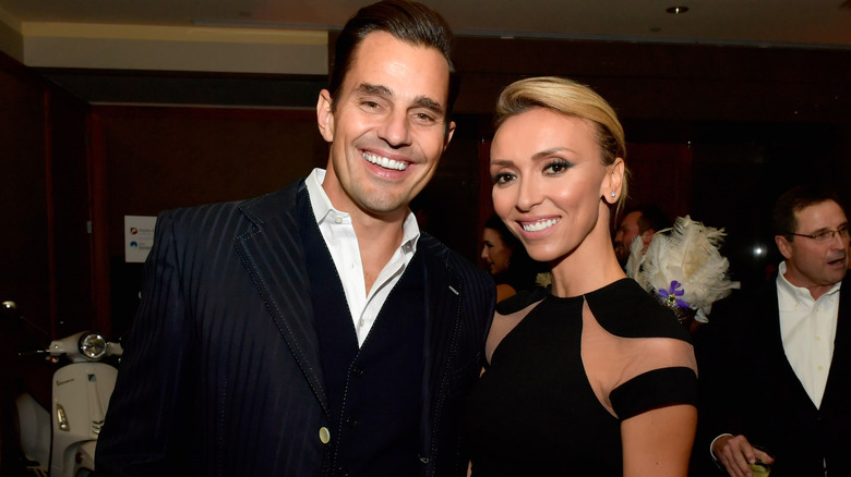 Bill and Giuliana Rancic smiling while posing together at an event