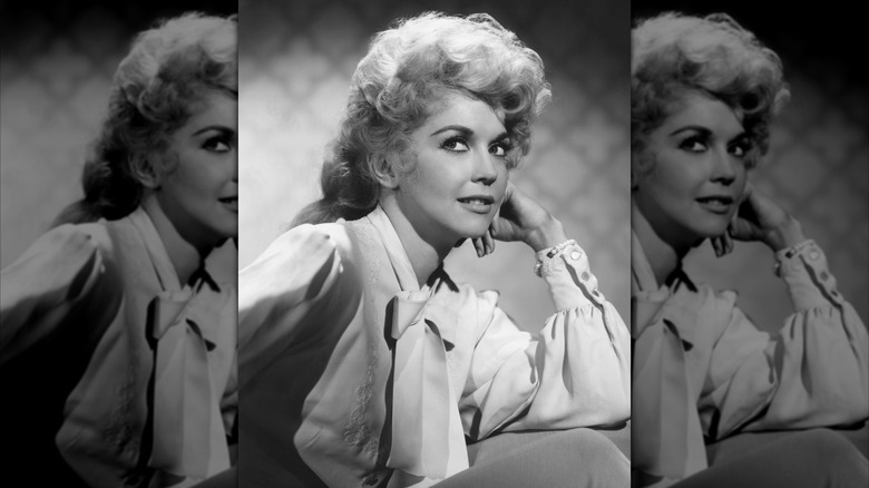 Donna Douglas in a bow-tie blouse posing for a portrait