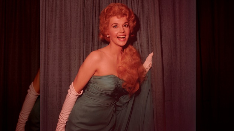 Donna Douglas in a green gown with white opera gloves at an event