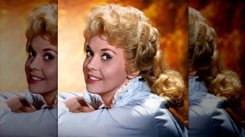 Donna Douglas in a pale blue blouse posing in a studio