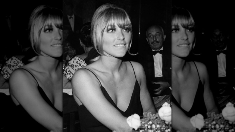 Sharon Tate at an event in a black sleeveless dress with flowers