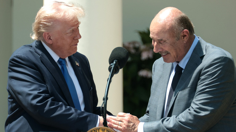 Donald Trump shaking hands with Dr. Phil