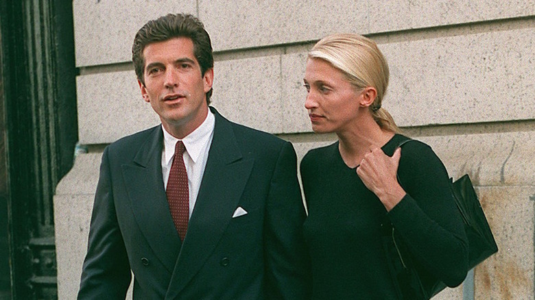 JFK Jr. and Carolyn Bessette outside apartment dark suits