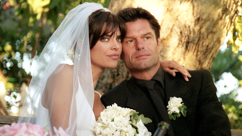 Lisa Rinna (wearing Vera Wang) and Harry Hamlin pose for a portrait in their garden where they were married on March 29, 1997 in Beverly Hills, California.