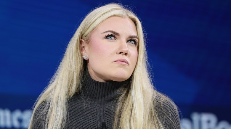 Erika Kirk in a gray sweater looking up.d