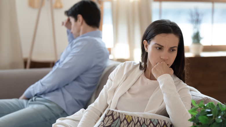 Arguing couple avoiding one another