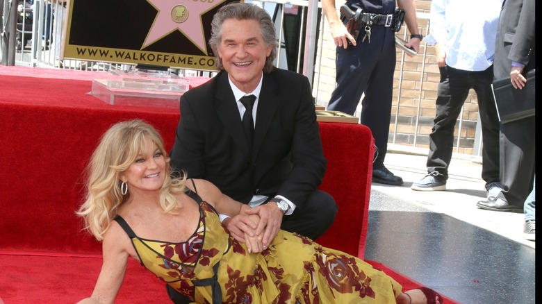 Goldie Hawn and Kurt Russell smiling on the Hollywood Walk of Fame