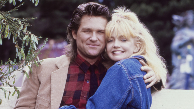 Kurt Russell and Goldie Hawn posing at Fort Bragg