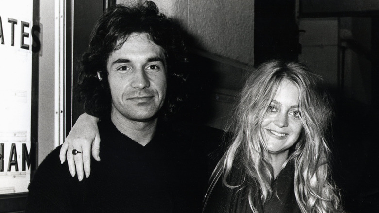 Bill Hudson and Goldie Hawn posing outside a venue