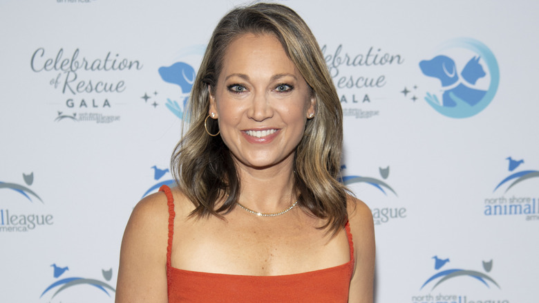 Ginger Zee smiling and wearing orange at a gala