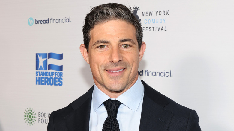 Matt Gutman smiling in a suit