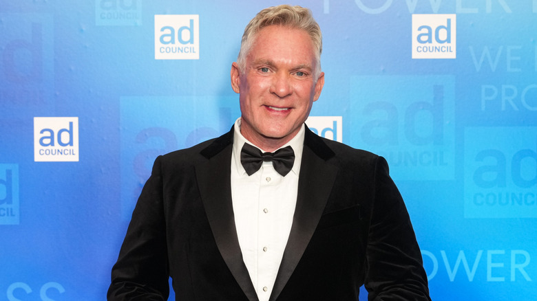 Sam Champion smiling in a smoking jacket and bowtie