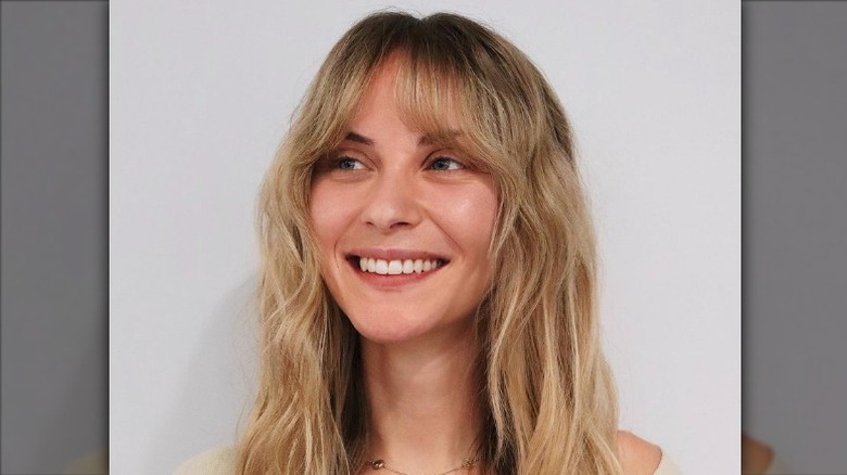 Woman with bottleneck bangs smiling