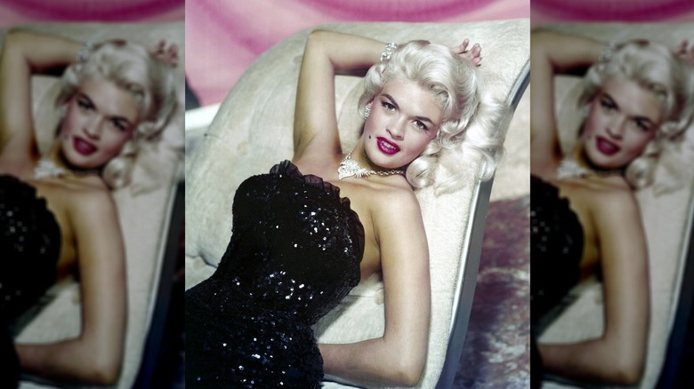 Jayne Mansfield (1933 - 1967) reclining on a chaise longue in a strapless, sequined gown and diamond jewelry, circa 1955