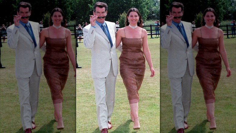 Pierce Brosnan and Keely Shaye Smith walking with their arms around each other