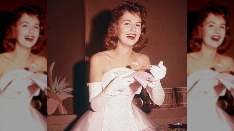 Shelley Fabares laughing while eating a piece of cake