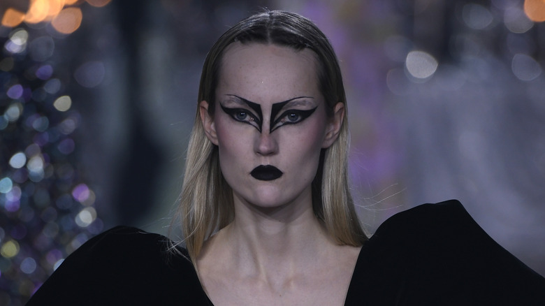 Model walks runway with goth fairy makeup