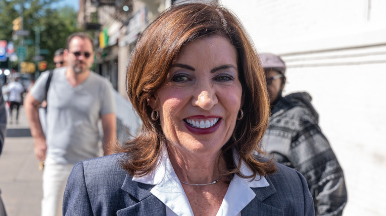 Close up on Kathy Hochul in a gray suit outside.