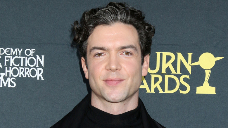 Ethan Peck smiling at event