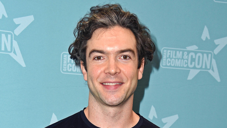 Ethan Peck smiling at an event