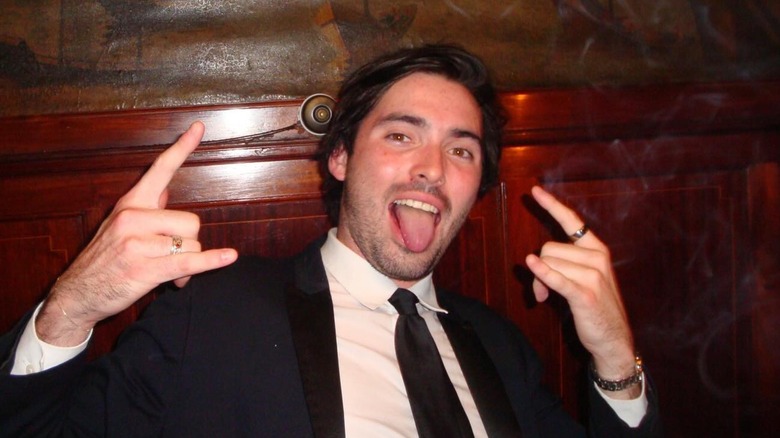 Harper Peck smiling in a suit and tie