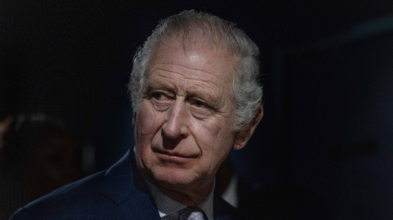 King Charles III looking somber
