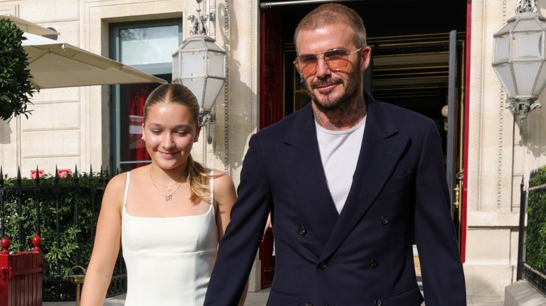 Harper and David Beckham holding hands