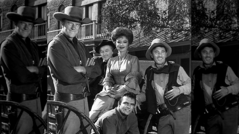 The cast of "Gunsmoke" on-set and posing for a promotional portrait