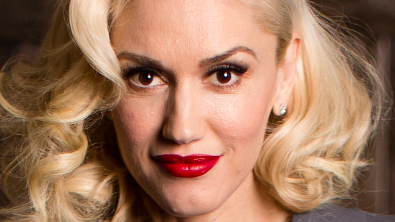 Gwen Stefani grinning with a perfectly applied red lip